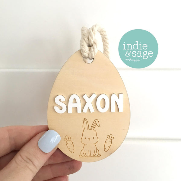 Easter Basket Name Tag - Egg Shaped Bunny Design personalised with your chosen name which will appear in raised white gloss acrylic. Handmade in Adelaide, these personalised Easter tags make a wonderful addition to Easter Gifts or Easter Baskets. Simply but oh so cute.