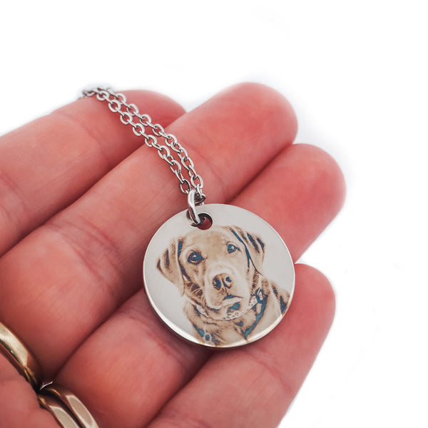 Engraved portrait of a labrador being held in the hand of its owner. Engraved using a image of your actual pet and hand made in our Adelaide Hills studio.