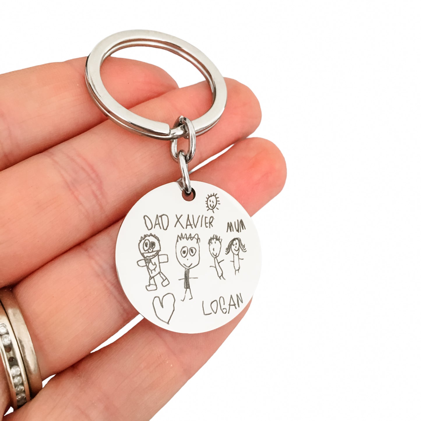 Childs drawing engraved onto a stainless steel pendant creating a beautiful personalised keepsake keyring.