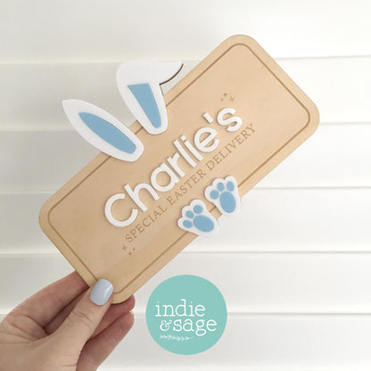 Personalised Easter crate sign made from plywood and acrylic, featuring bunny ears and a custom child’s name. Handmade in Adelaide Hills, this Easter box plaque reads “Special Easter Delivery” and is designed to attach to a wooden crate for Easter morning surprises.

#FirstEaster
#BabyFirstEaster
#PersonalisedEasterGift
#CustomEasterSign
#EasterGiftForKids
#EasterKeepsake
#EasterCrateSign
#EasterBasketIdeas
#HandmadeEasterGift
#UniqueEasterGift
#EasterGiftAustralia
#Easter2026