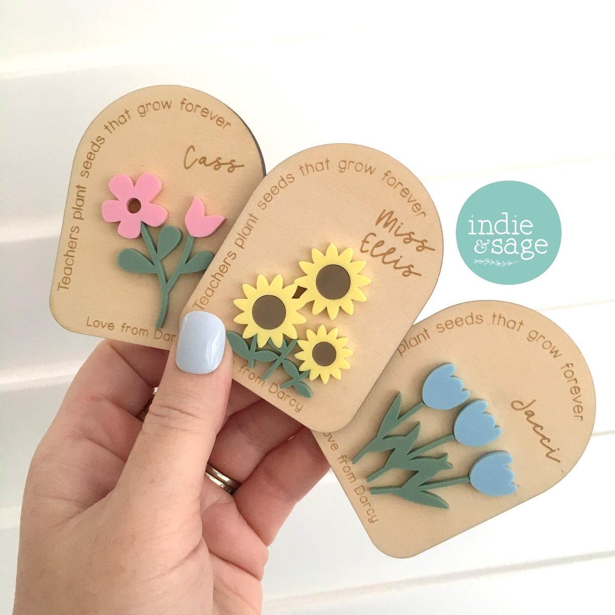 Personalised teacher gift magnet showing custom teacher and student names engraved on wooden backing with acrylic flowers