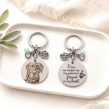 Personalised double-sided pet memorial keychain displayed on a ceramic trinket tray, featuring a custom laser engraved dog portrait on one side and a heartfelt memorial message engraved on the reverse.