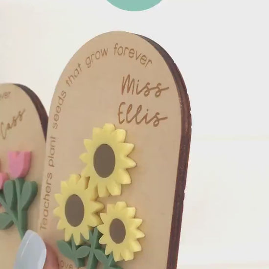 Close-up of personalised teacher appreciation magnet with engraved teacher name and colourful layered flower design