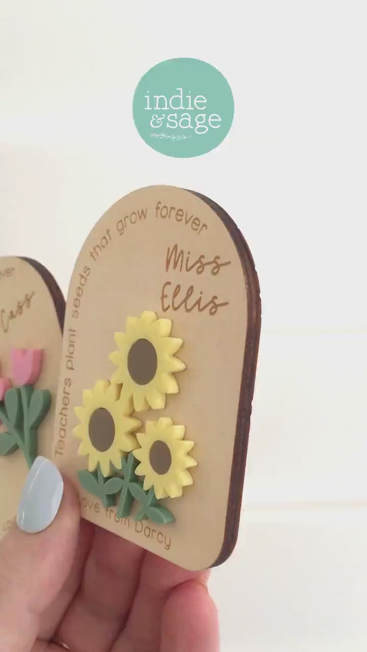 Close-up of personalised teacher appreciation magnet with engraved teacher name and colourful layered flower design