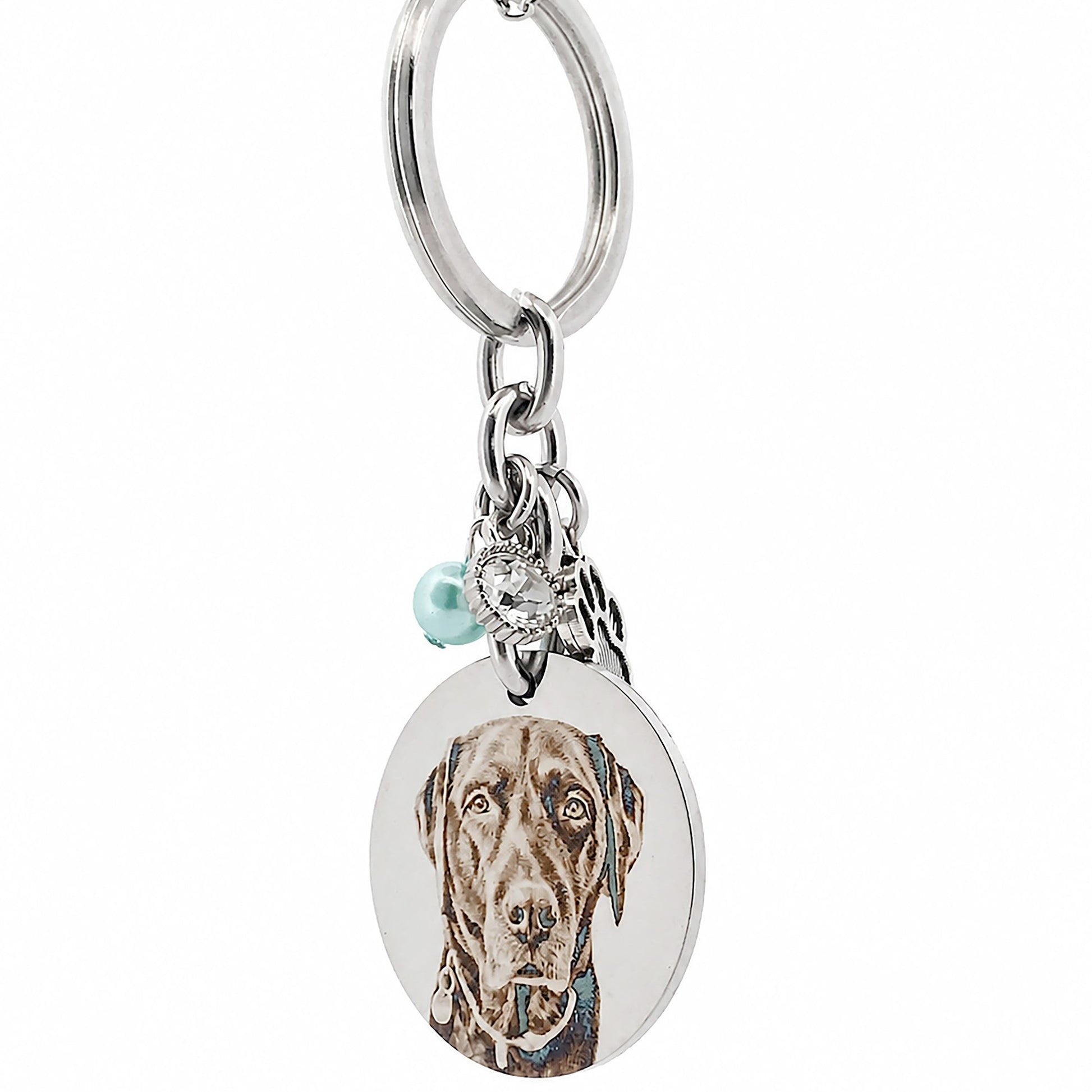 Side profile of a stainless steel personalised pet memorial keychain highlighting the engraved pendant, paw charm, birthstone bead and premium craftsmanship.
