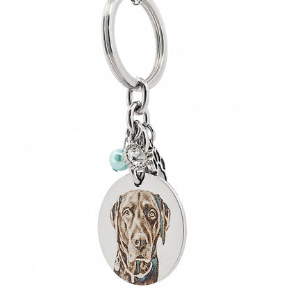 Side profile of a stainless steel personalised pet memorial keychain highlighting the engraved pendant, paw charm, birthstone bead and premium craftsmanship.